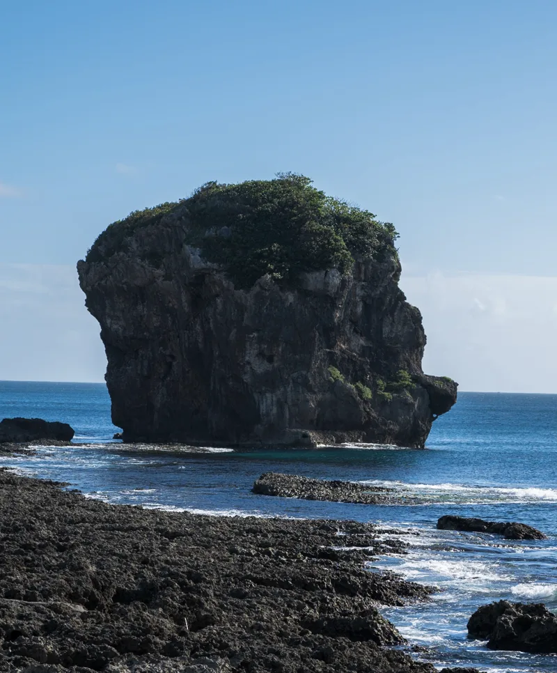 Chuanfan Rock sea stack off the Kenting coast in turquoise water