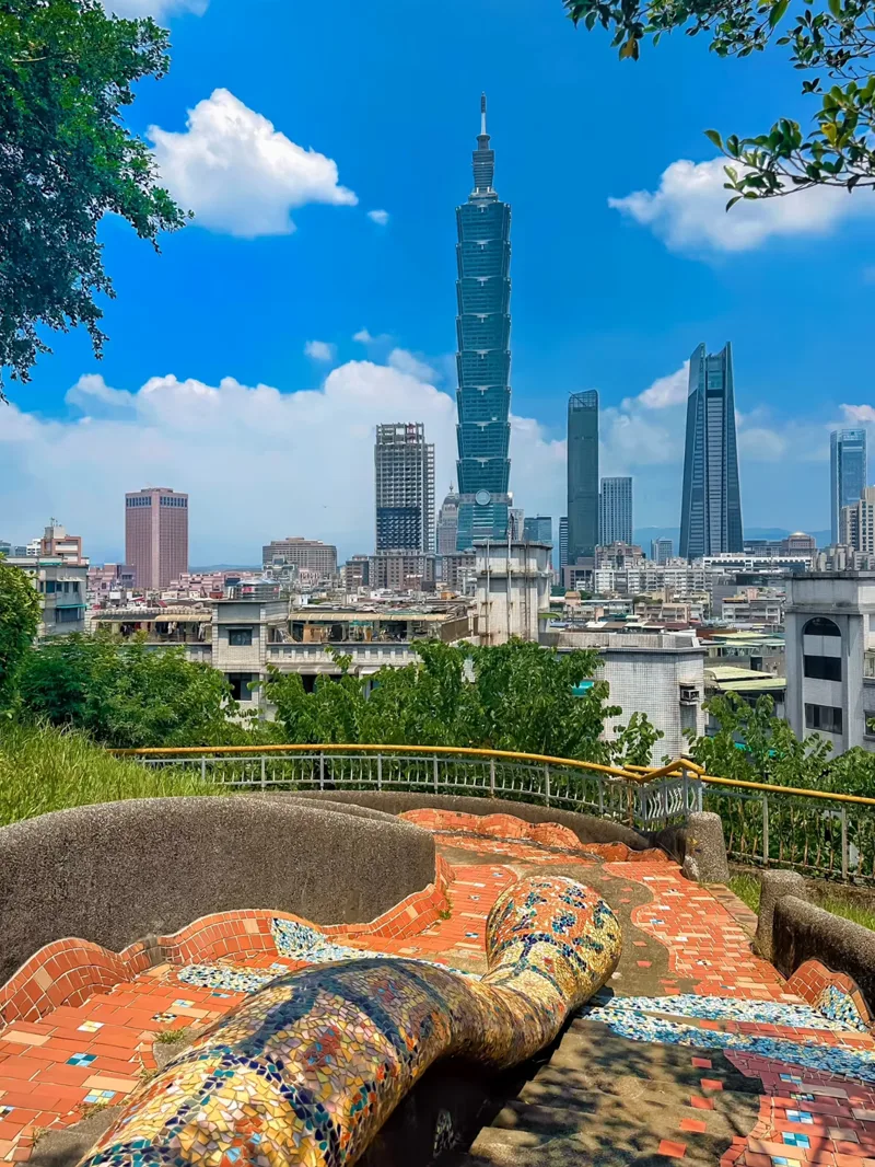 Taipei 101 over the city from a tiled hillside lookout on a clear day